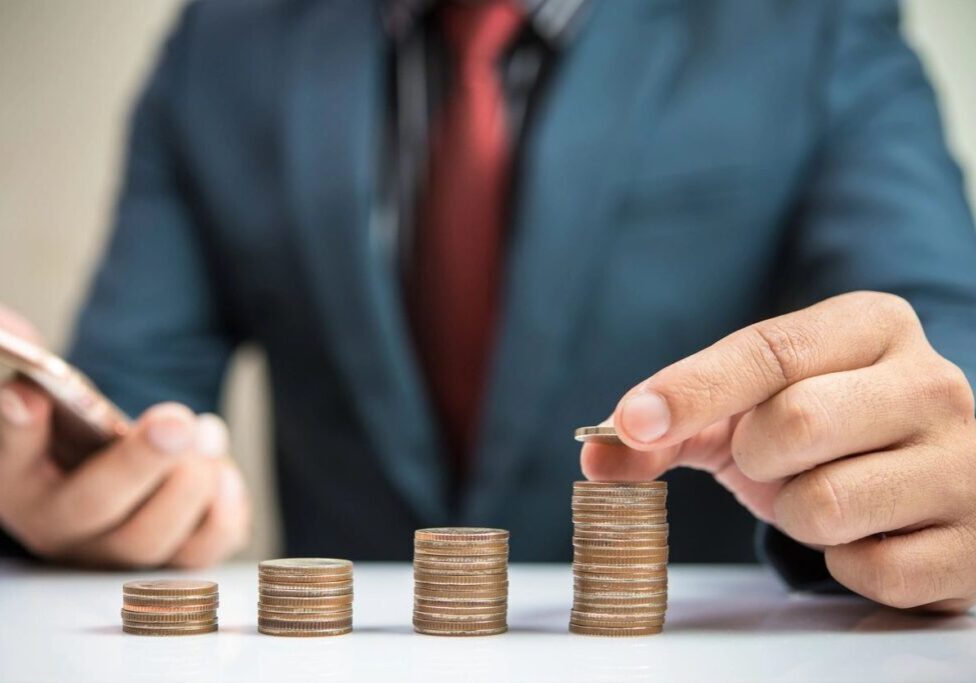 A Person Stacking Up Coins